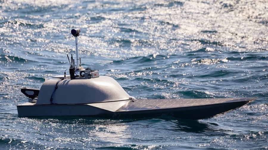 Small low-cost boat retrofitted with a sensor mast and solar deck, running unmanned